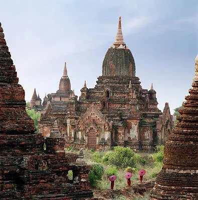 buddhist-monks-walking-past-temple-martin-puddy